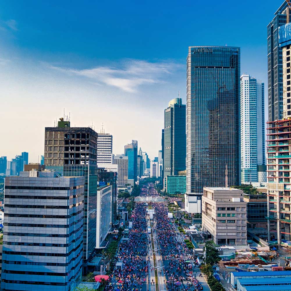 A street fair in a busy city with tall buildings