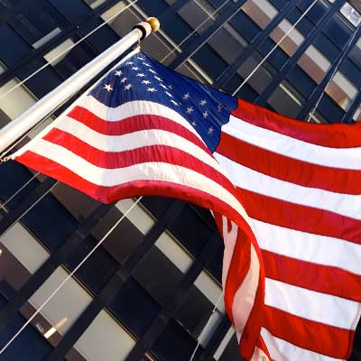 The American flag flies in front of a building