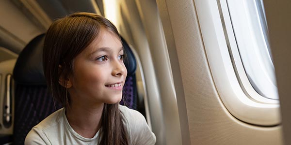 A child looks out of an airplane window