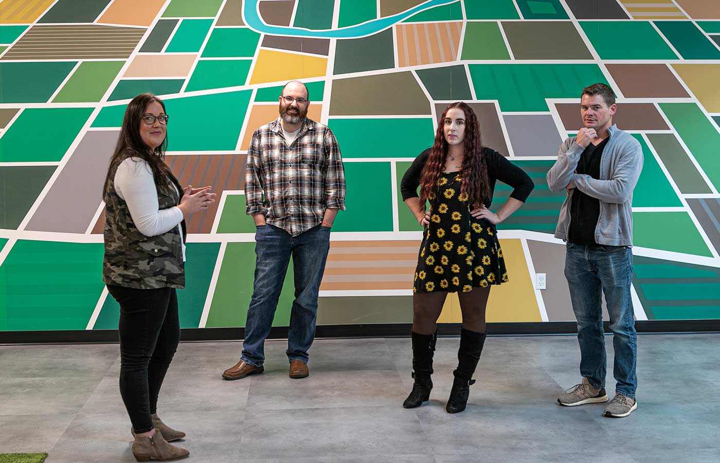 LimoLink team members stand in front of a painted mural