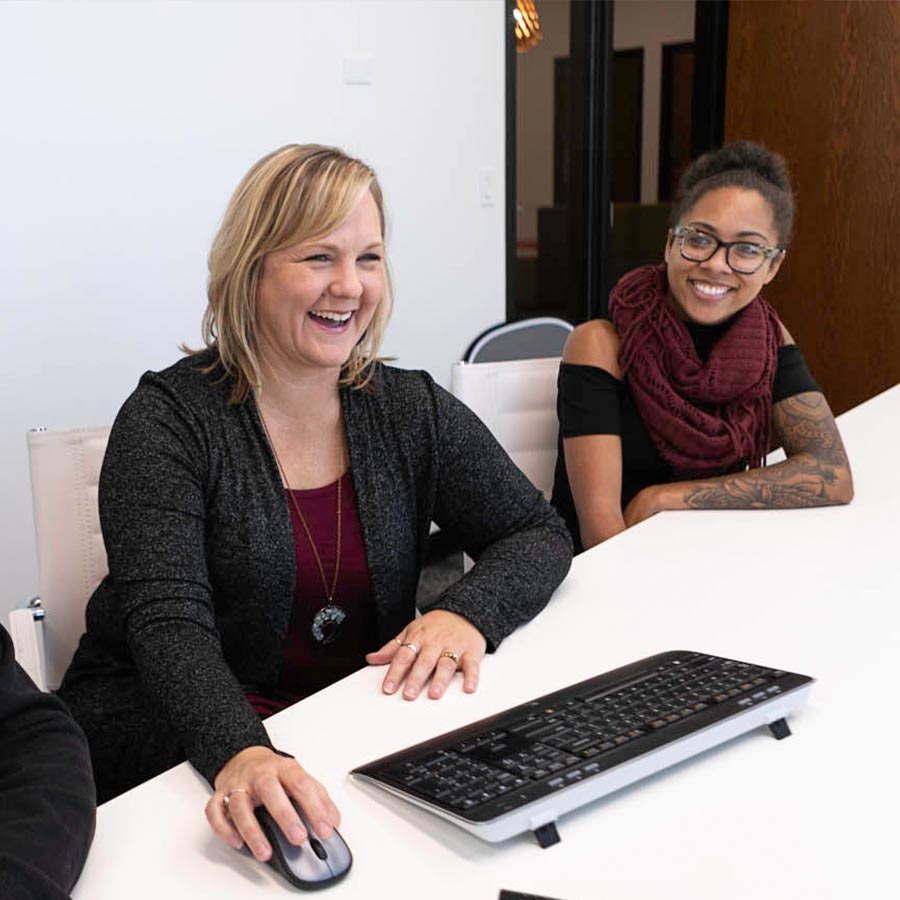 LimoLink employees sit at a conference room table